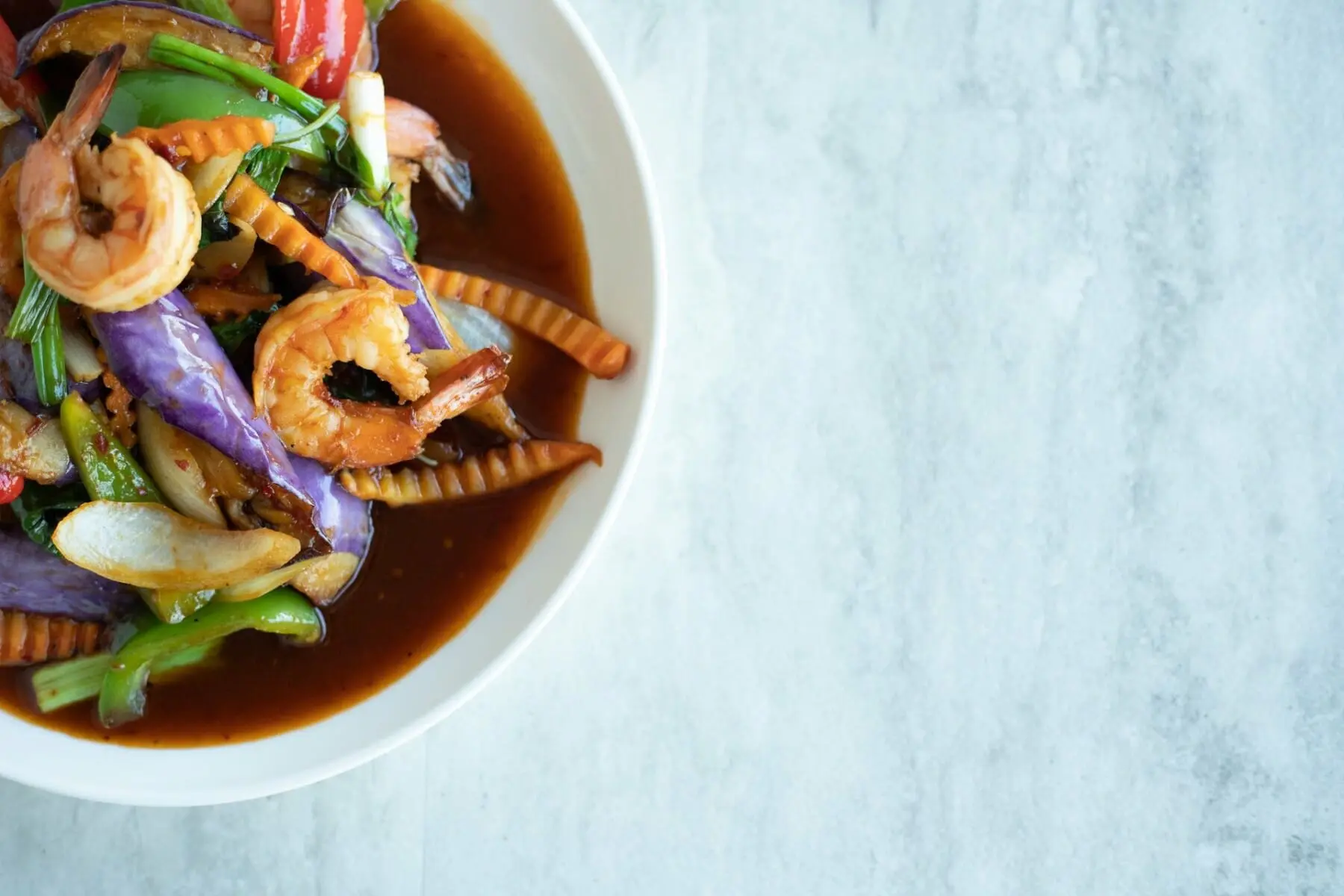 Broadway Nashville honky tonk neon lights at night with live country music spilling onto the street