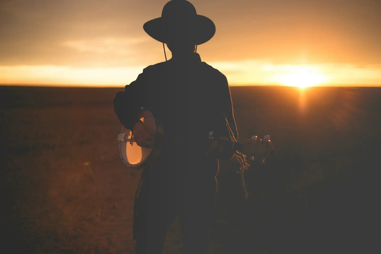 Country music musician at sunset evoking Nashville country music heritage