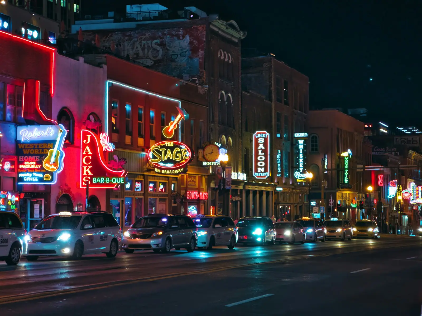 Lower Broadway in Nashville lit up with neon honky tonk signs at night