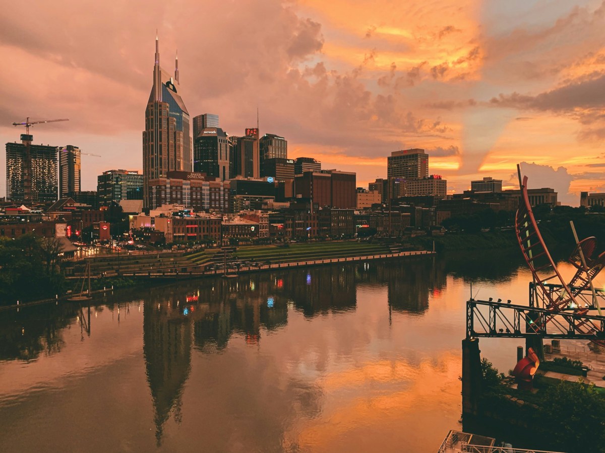 Nashville skyline at sunset over the Cumberland River — Music City Magnolia vacation rentals