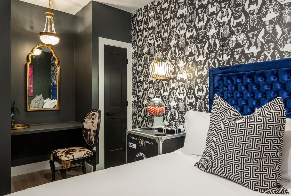 Honky Tonk Party Pad bedroom — blue velvet headboard, cowboy wallpaper