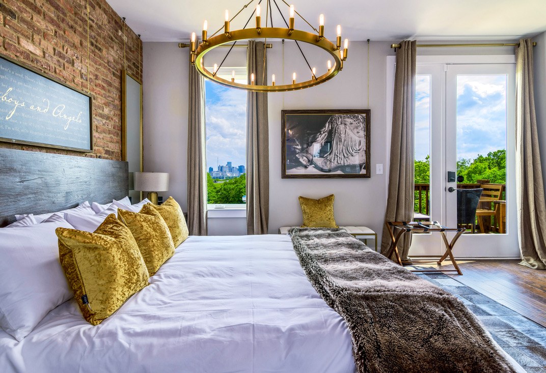Nashville vacation rental bedroom with skyline view and gold chandelier
