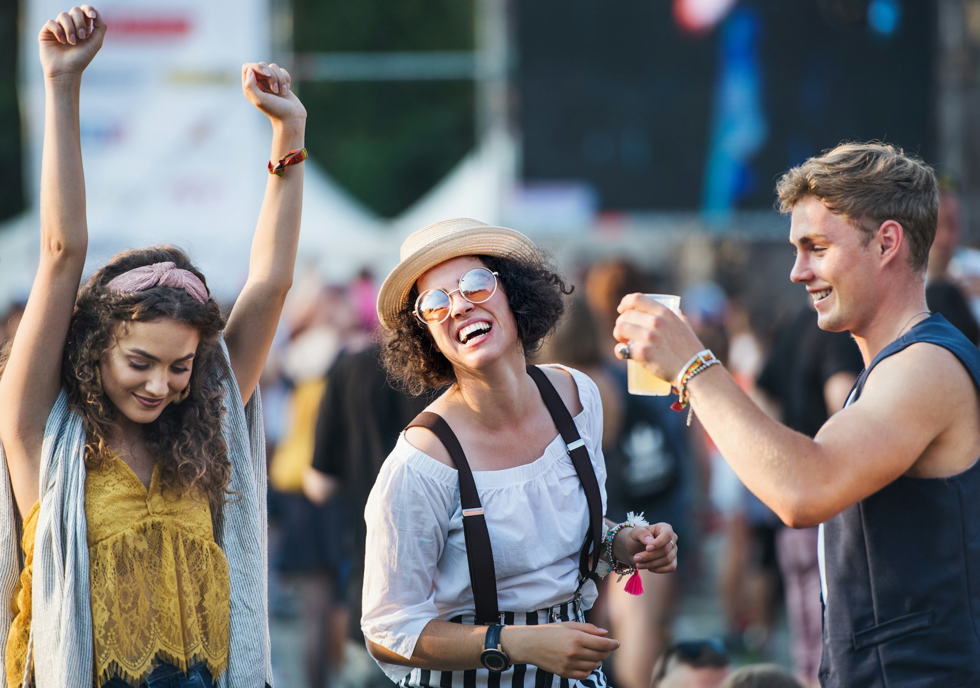 Group of friends celebrating at a summer music festival together