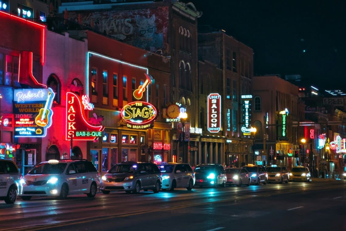 Lower Broadway in Nashville lit up with neon honky tonk signs at night