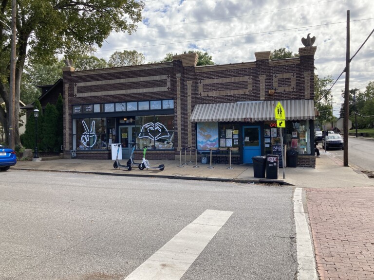 East Nashville Fatherland District shopping strip — the historic brick corner storefronts on Fatherland Street with indie boutiques, gift shops, and a neighborhood cafe